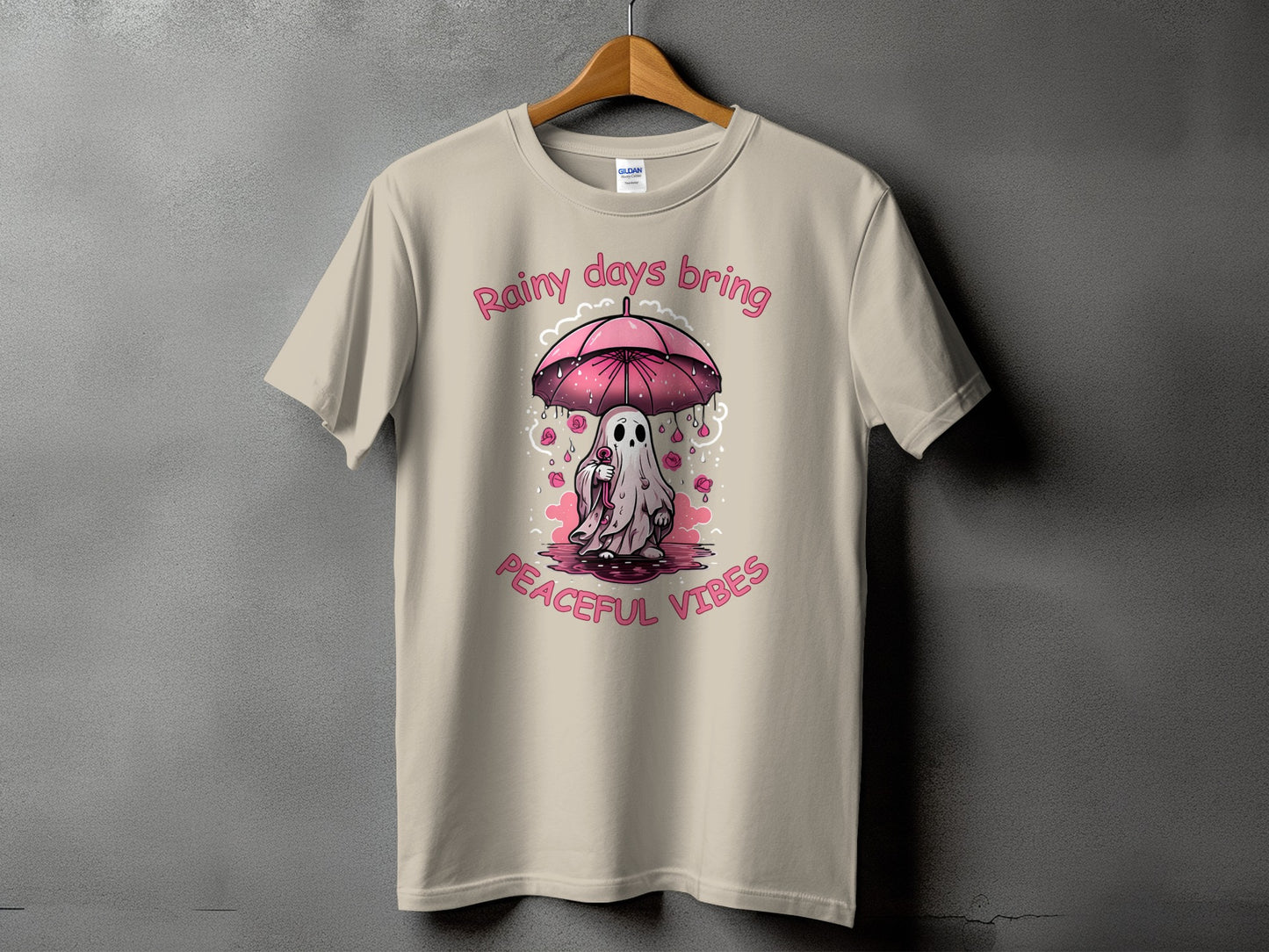 T-shirt with a ghost holding an umbrella and the text "Rainy days bring peaceful vibes".