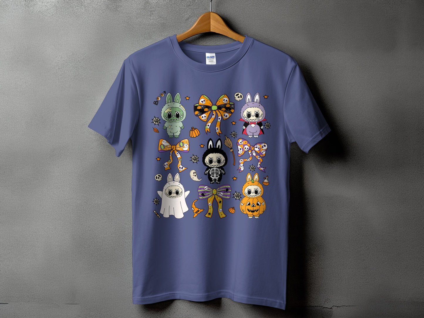 Purple t-shirt with Halloween-themed cartoon characters including ghosts, skeletons, pumpkins, and bunnies.