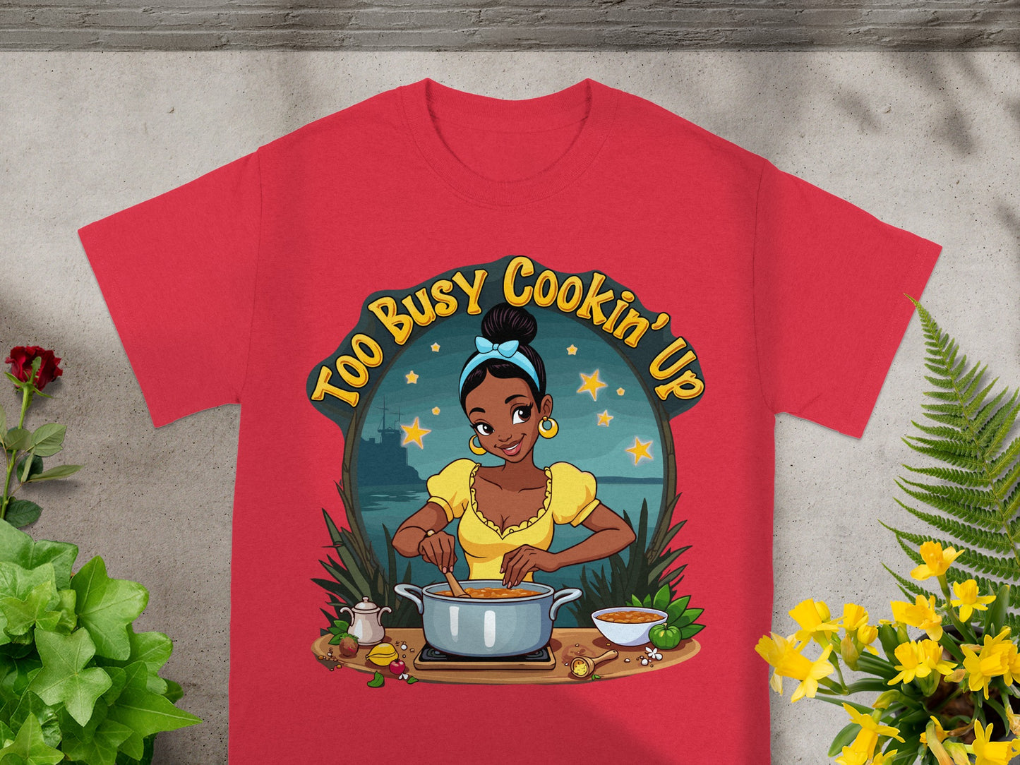 Red t-shirt featuring a cartoon woman cooking with the text "Too Busy Cookin' Up".