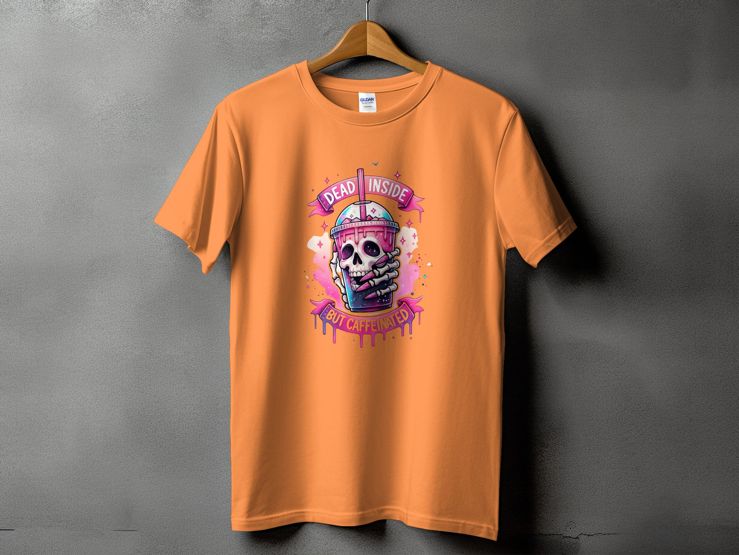 Orange t-shirt with a skull holding a colorful drink and text "Dead Inside But Caffeinated".