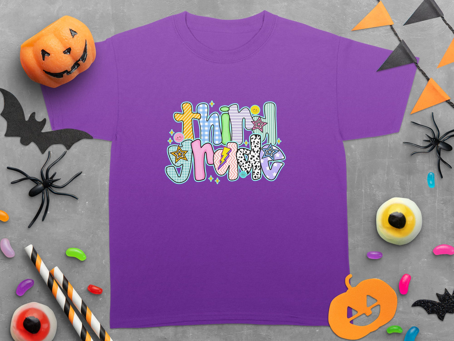 Purple t-shirt with "Third Grade" text and Halloween decorations.