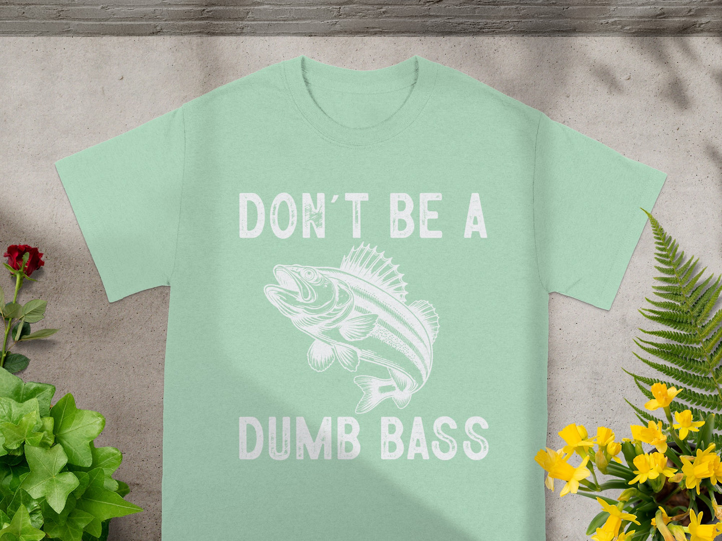 Light green t-shirt with white text "DON'T BE A DUMB BASS" and fish graphic.