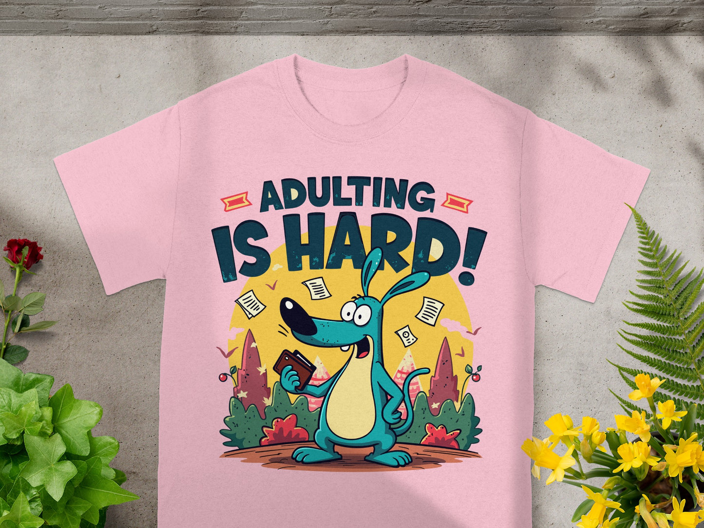 Pink t-shirt with cartoon dog and text "ADULTING IS HARD!".