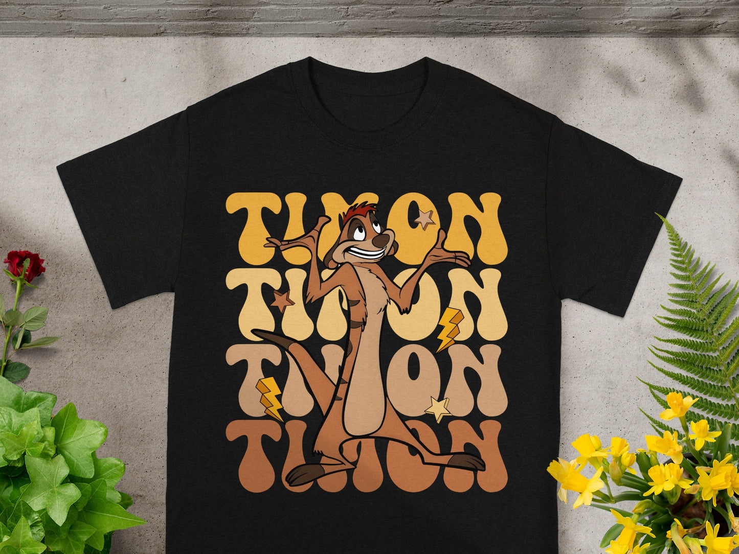 Black t-shirt with retro "Timon" graphic featuring lightning bolts and a cartoon meerkat.