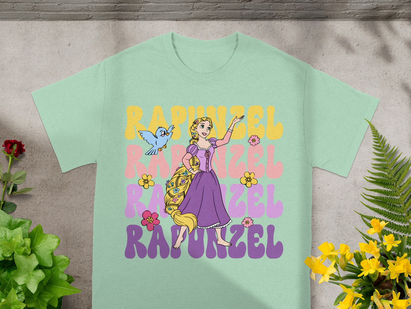 Light mint green t-shirt with Rapunzel illustration and text.