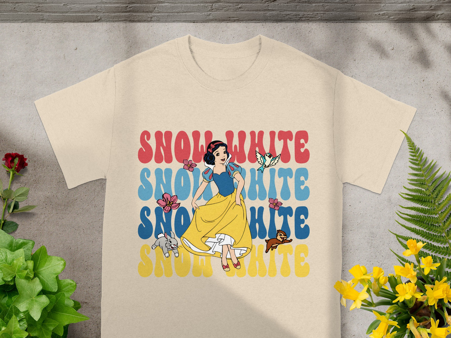 Snow White title graphic with stylized text and characters on a t-shirt.