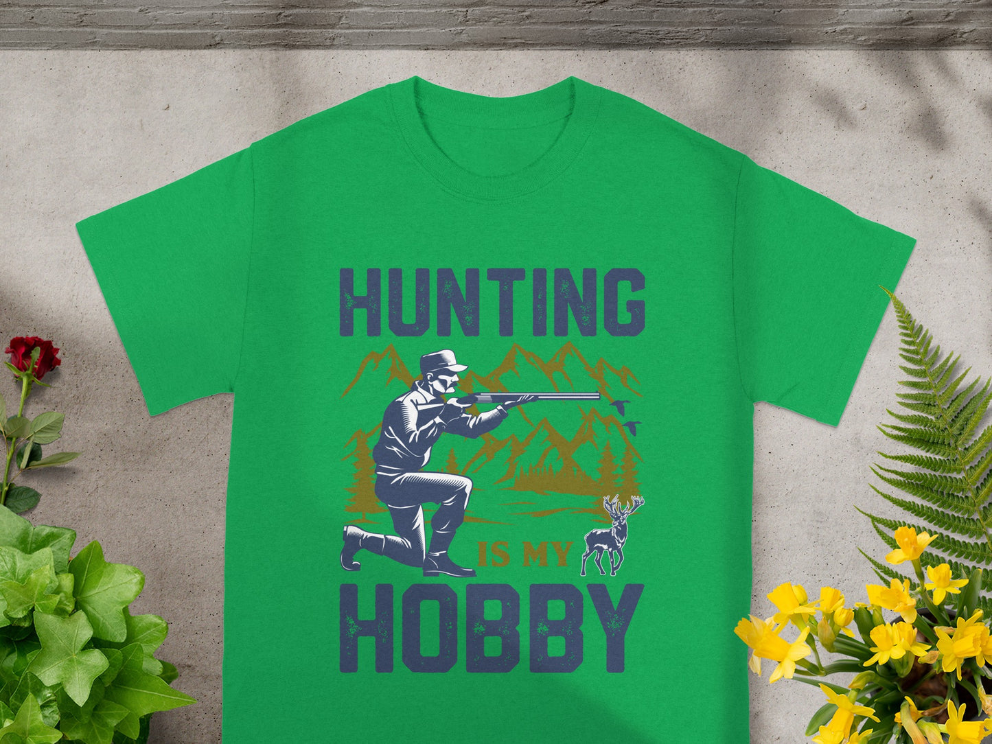 Green t-shirt with "Hunting Is My Hobby" graphic and hunter aiming rifle.