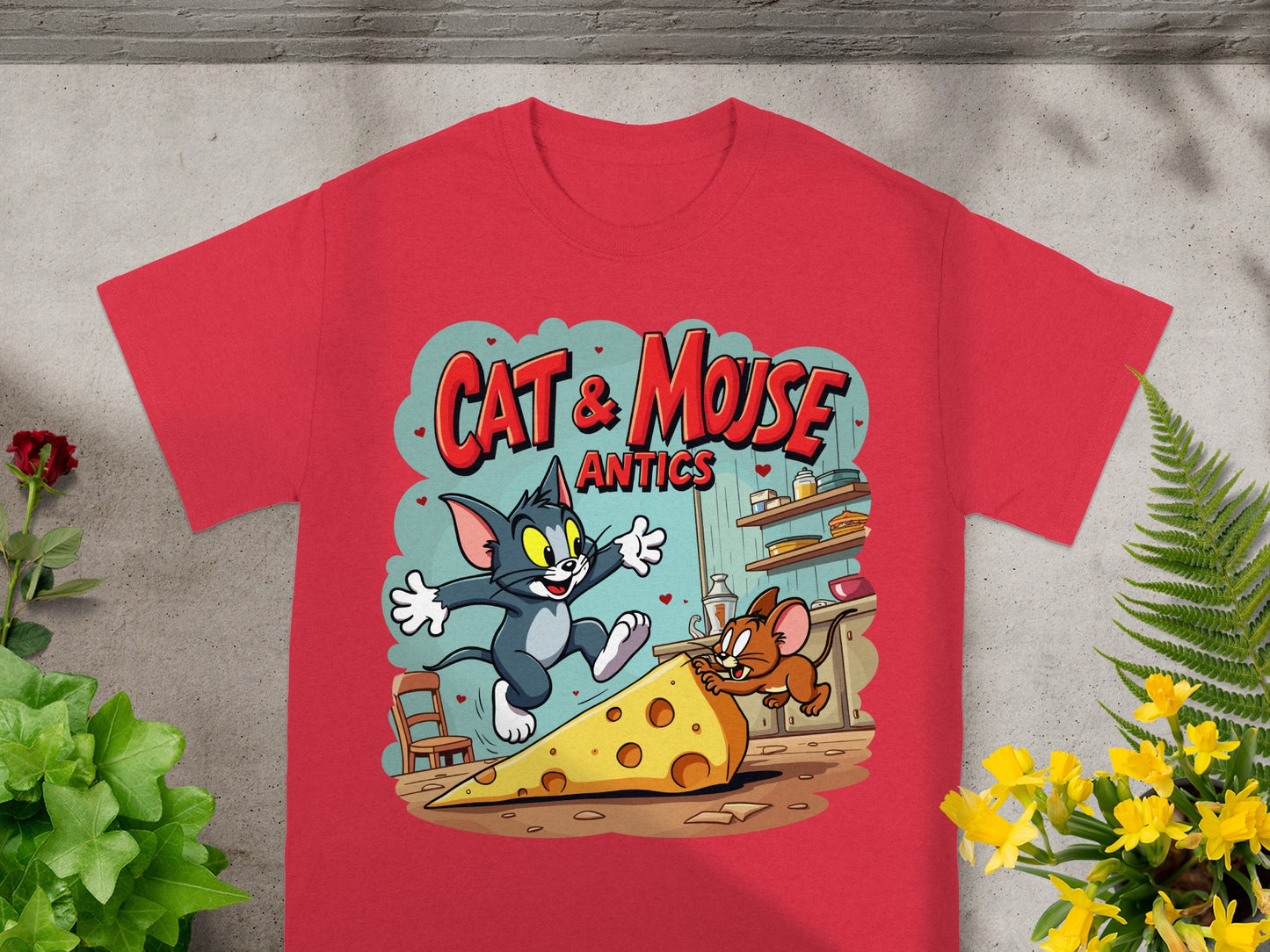 Red t-shirt with Cat & Mouse Antics graphic featuring cartoon cat chasing mouse with large cheese slice.
