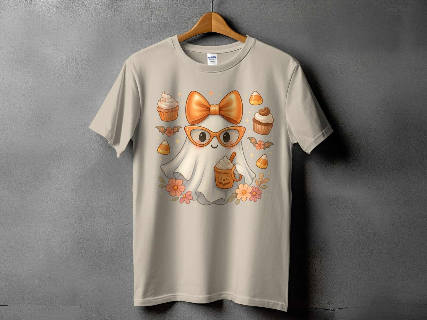 Light tan t-shirt with a cute ghost wearing glasses and an orange bow.