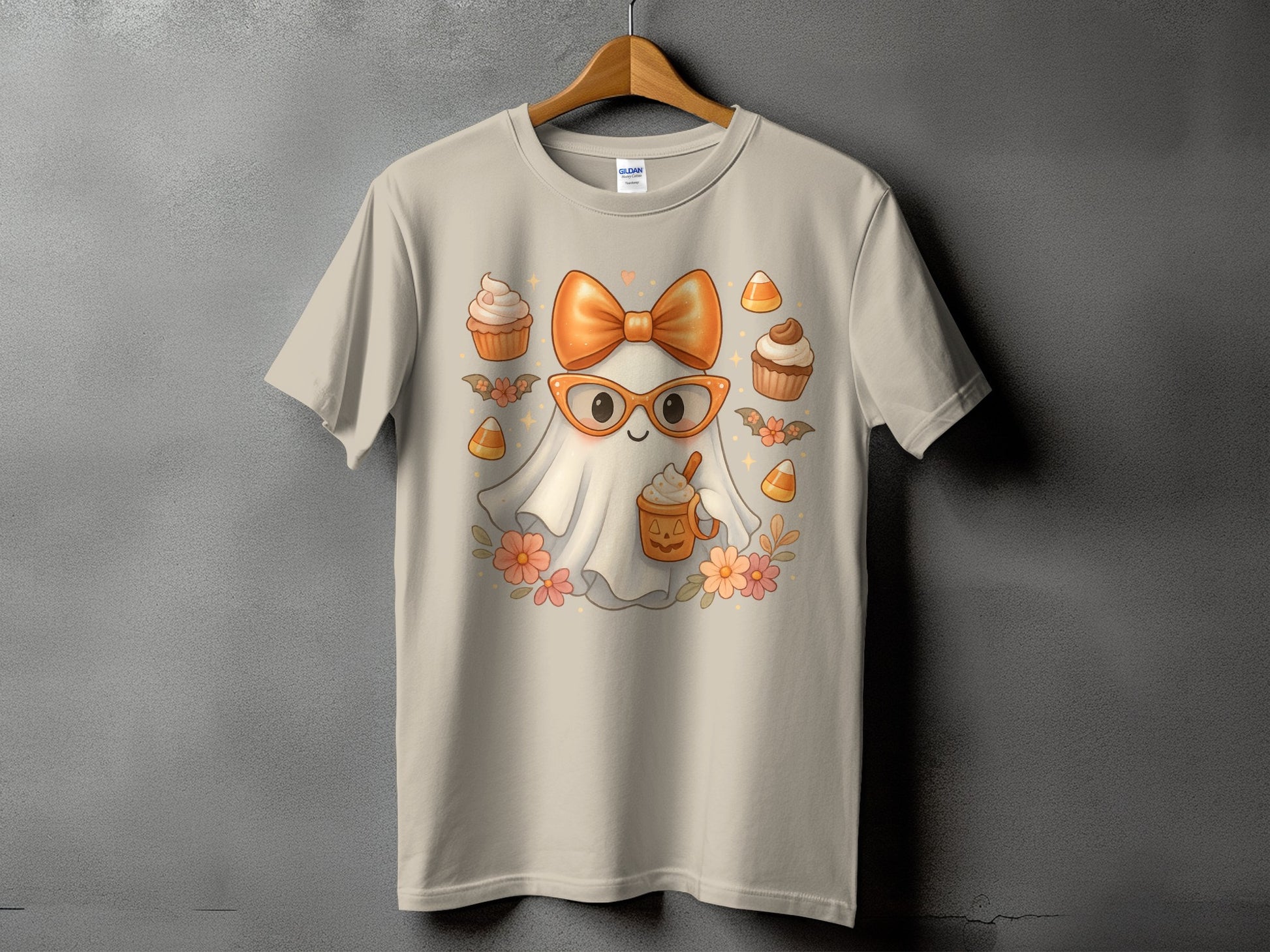 Light tan t-shirt with a cute ghost wearing glasses and an orange bow.