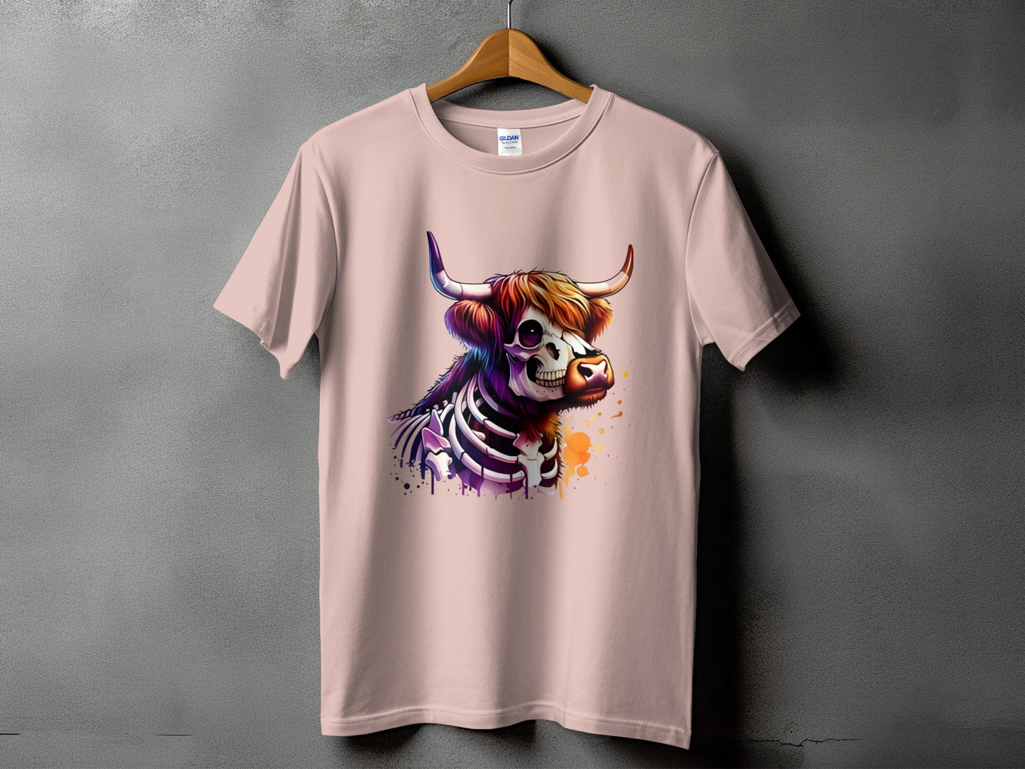 Pink t-shirt with a colorful skeleton bull graphic and paint splatters.
