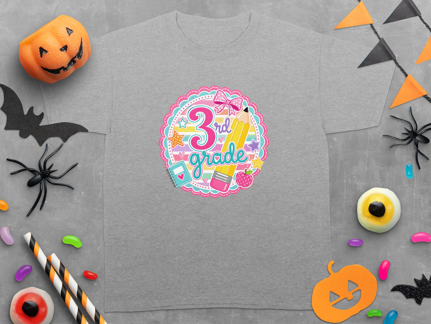 Grey t-shirt with "3rd grade" text and school supplies in a decorative circle.