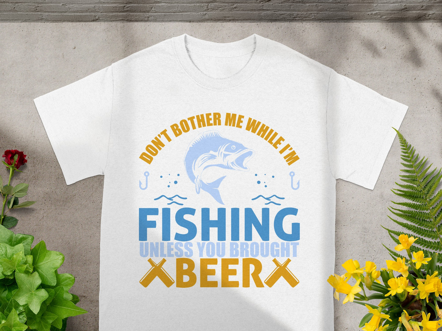 White t-shirt graphic with "Don't bother me while I'm fishing unless you brought XBEER X".