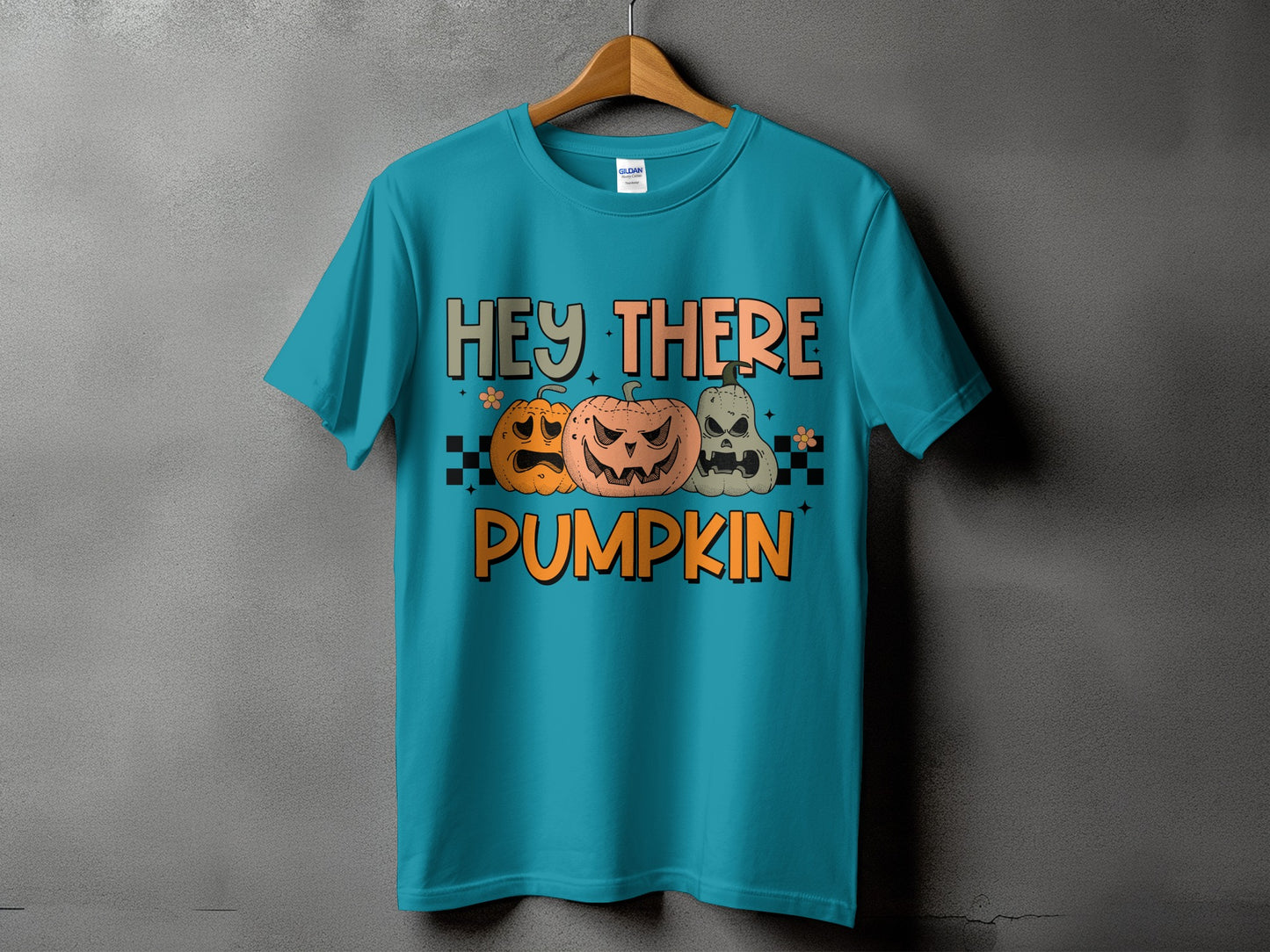Teal t-shirt with "Hey There Pumpkin" text and three cartoon pumpkins.
