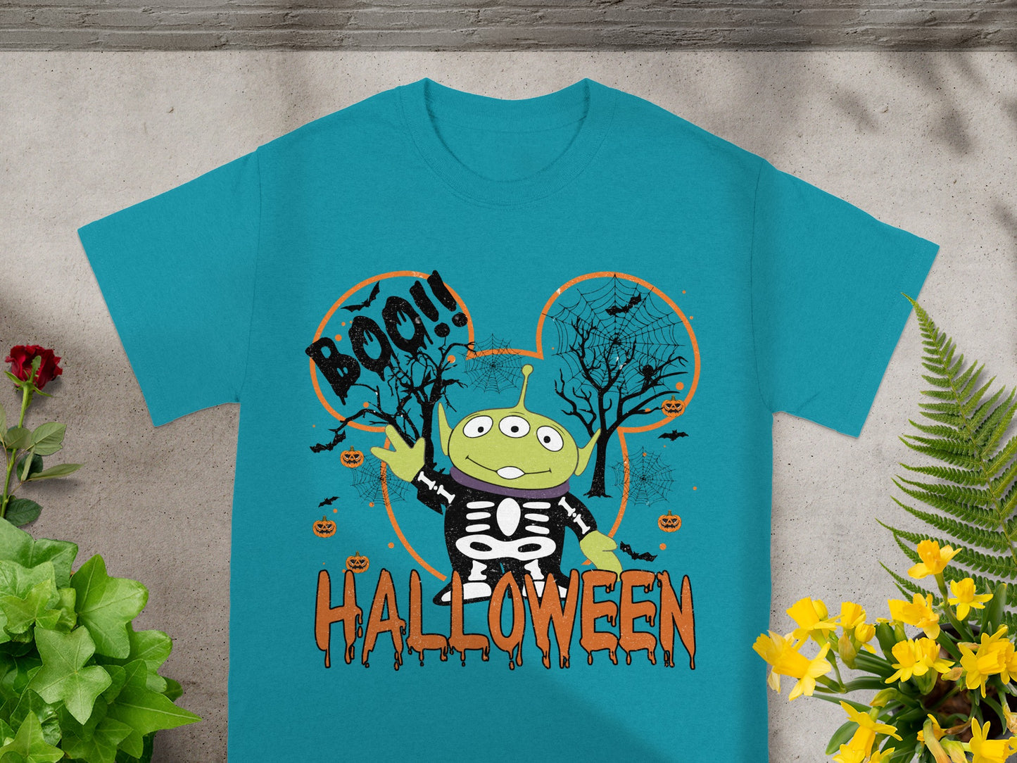Toy Story alien in skeleton costume on Halloween themed shirt with "BOO!!" and "HALLOWEEN".