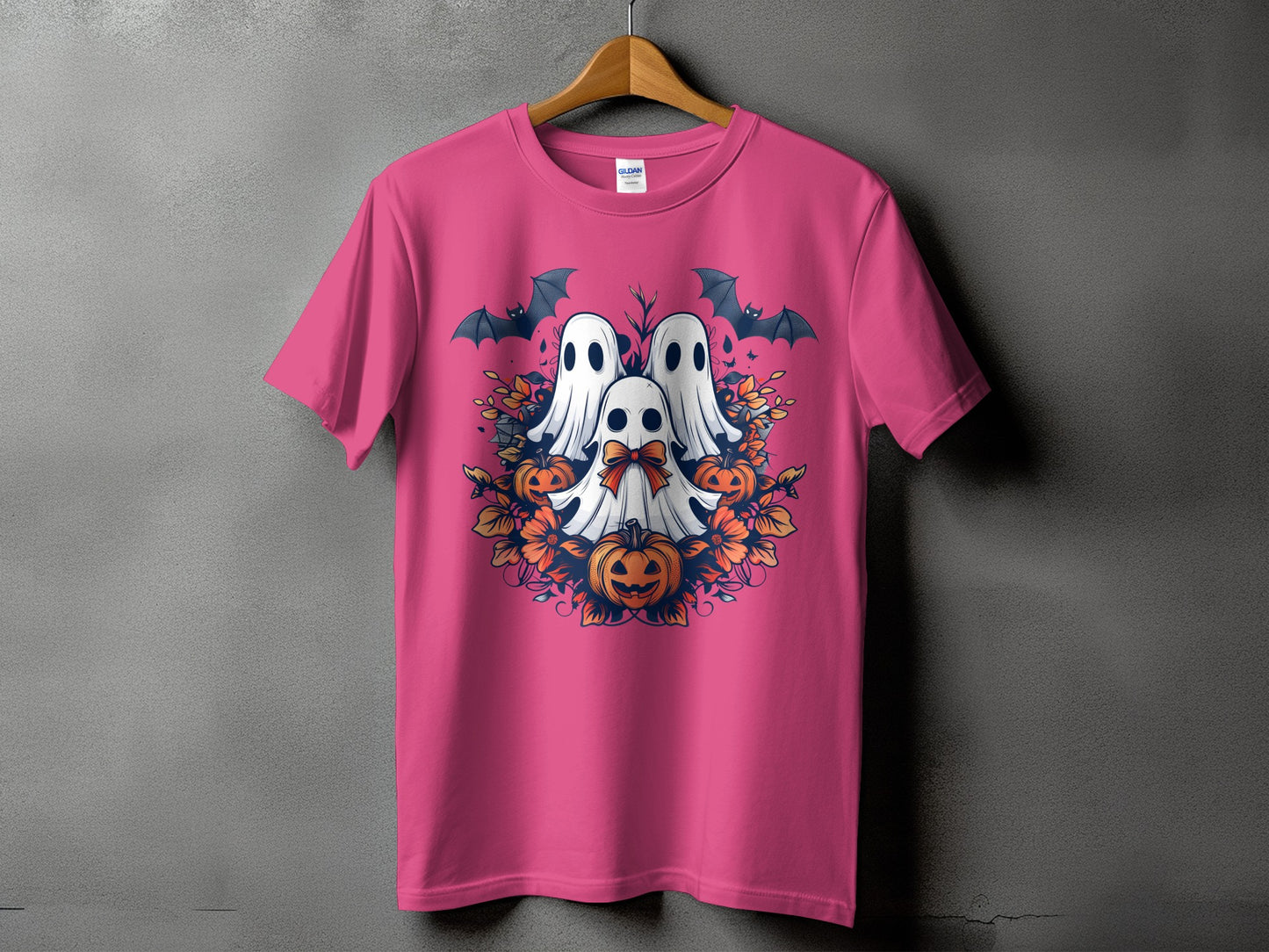Pink t-shirt with a Halloween graphic of ghosts, pumpkins, bats, and autumn leaves.