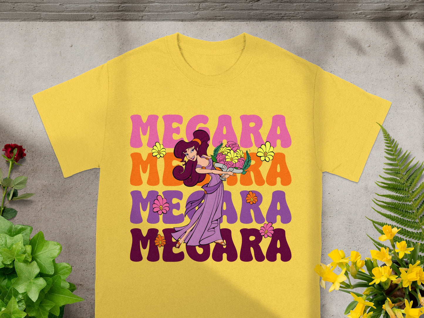 Yellow t-shirt with "MEGARA" in large, colorful letters and a cartoon character.