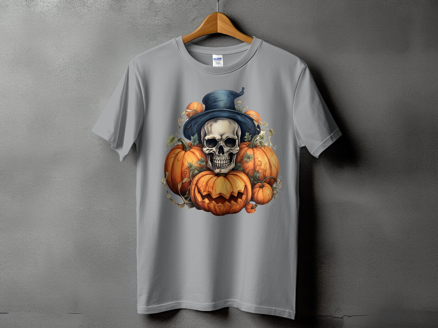 Skull and pumpkins with a witch hat graphic on a grey t-shirt.