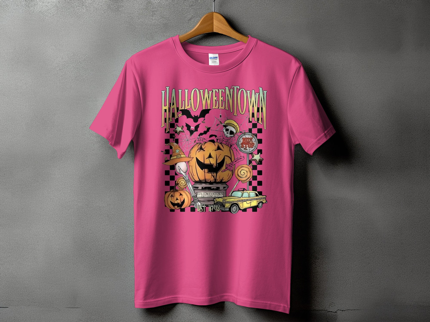 Pink t-shirt with "Halloweentown" graphic featuring pumpkins, bats, skulls, and a taxi.