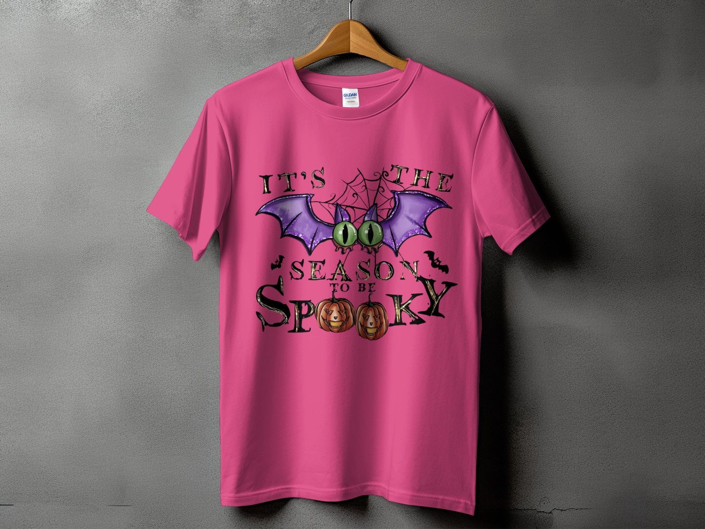 Pink t-shirt with "It's the season to be spooky" Halloween graphic.