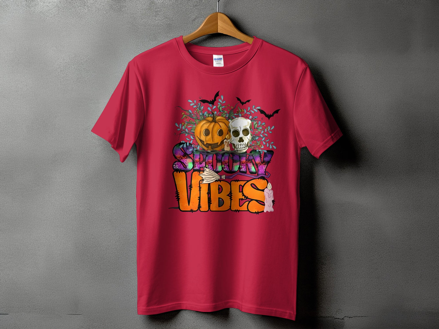 Red t-shirt with Halloween design featuring pumpkin, skull, bats, and "Spooky Vibes" text.
