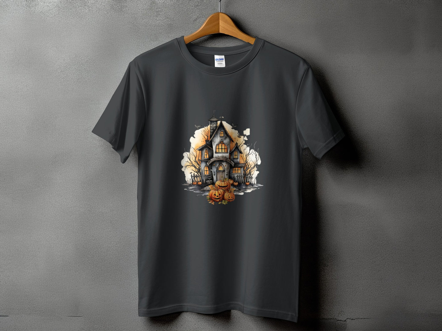 Dark grey t-shirt with a watercolor graphic of a haunted house and pumpkins.