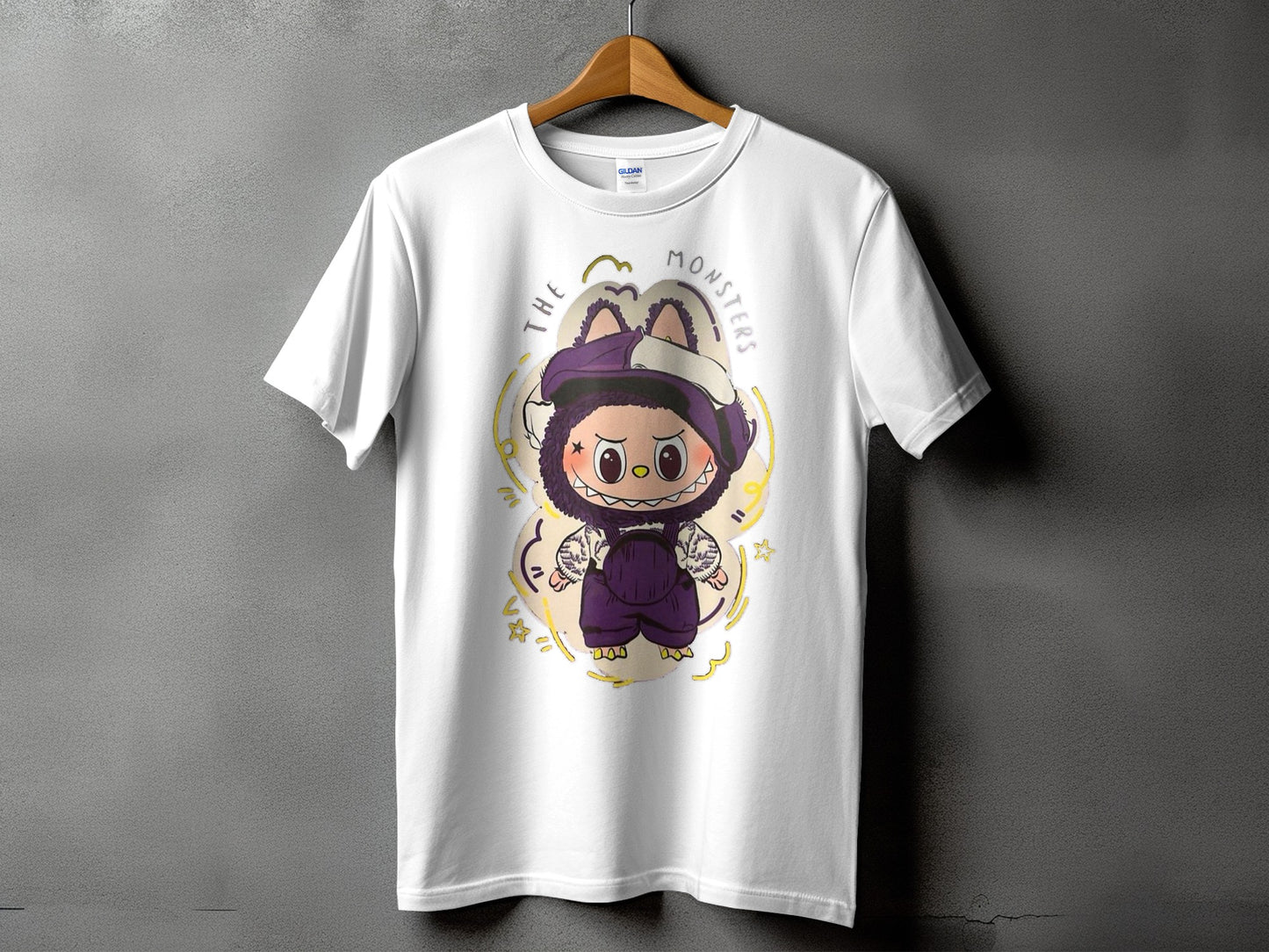 White t-shirt with cartoon monster wearing overalls and purple hat, text "THE MONSTERS".