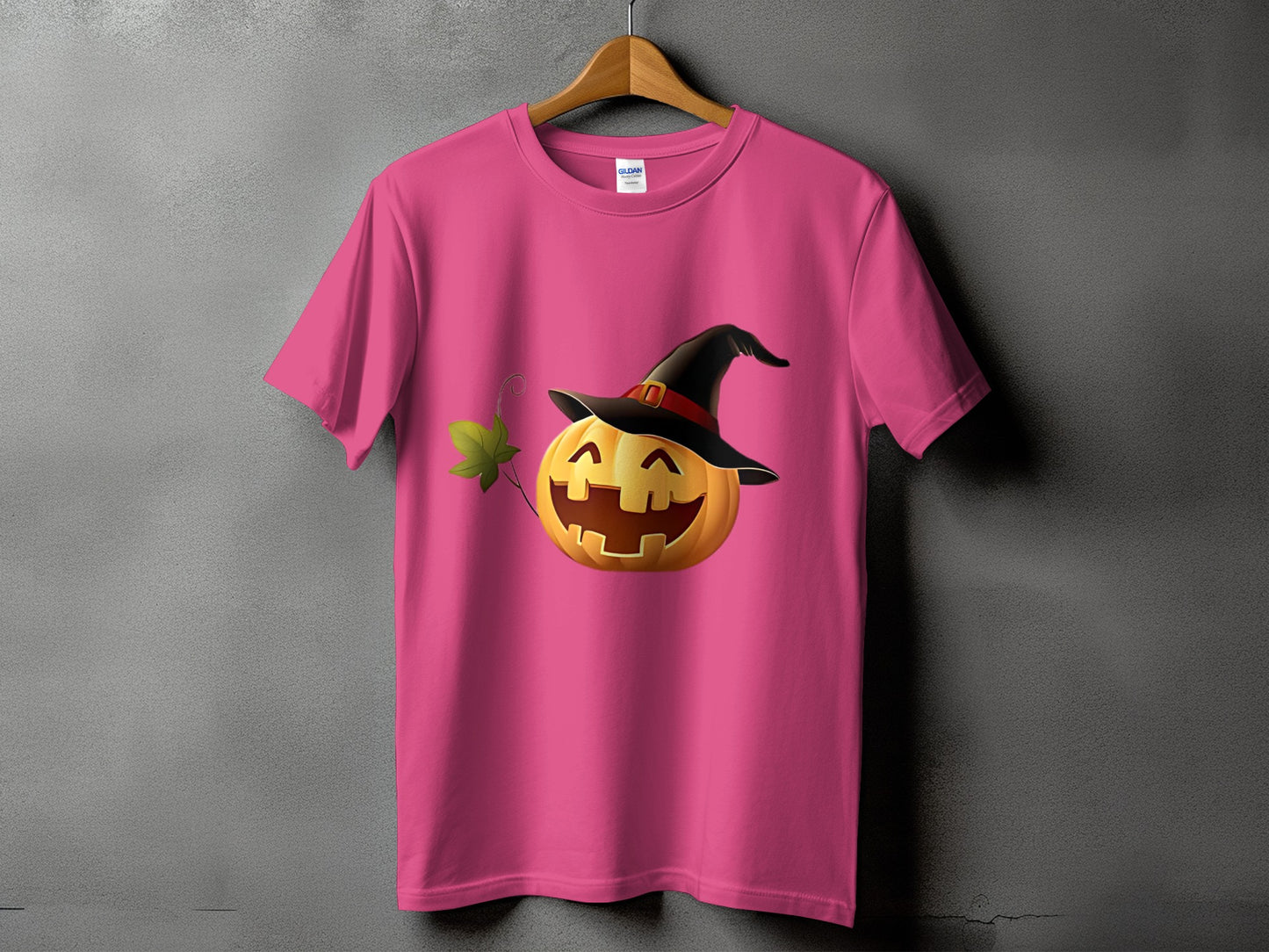 Pink t-shirt with a jack-o'-lantern wearing a witch hat.