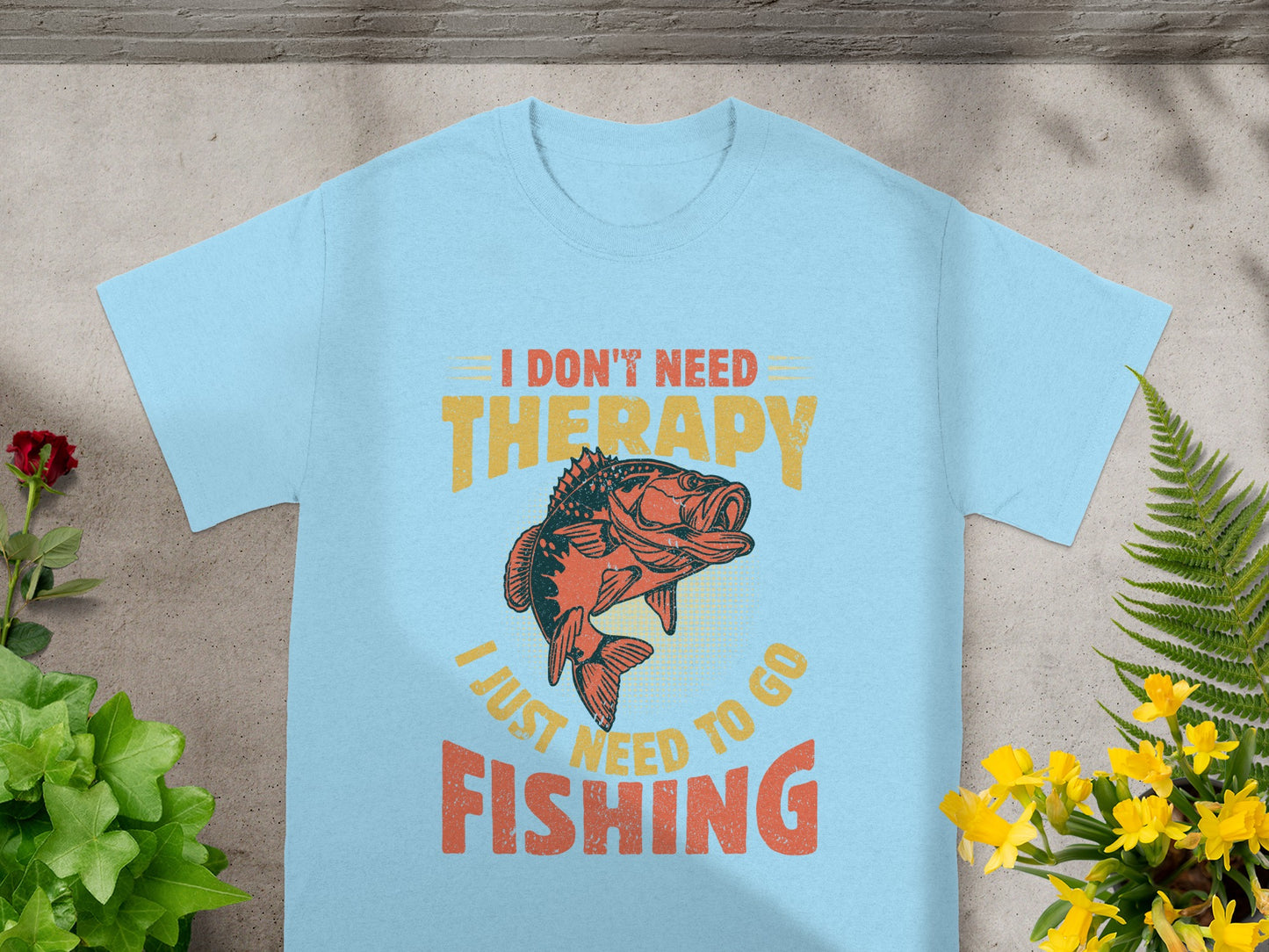 Light blue t-shirt with fish graphic and text: "I don't need therapy, I just need to go fishing."