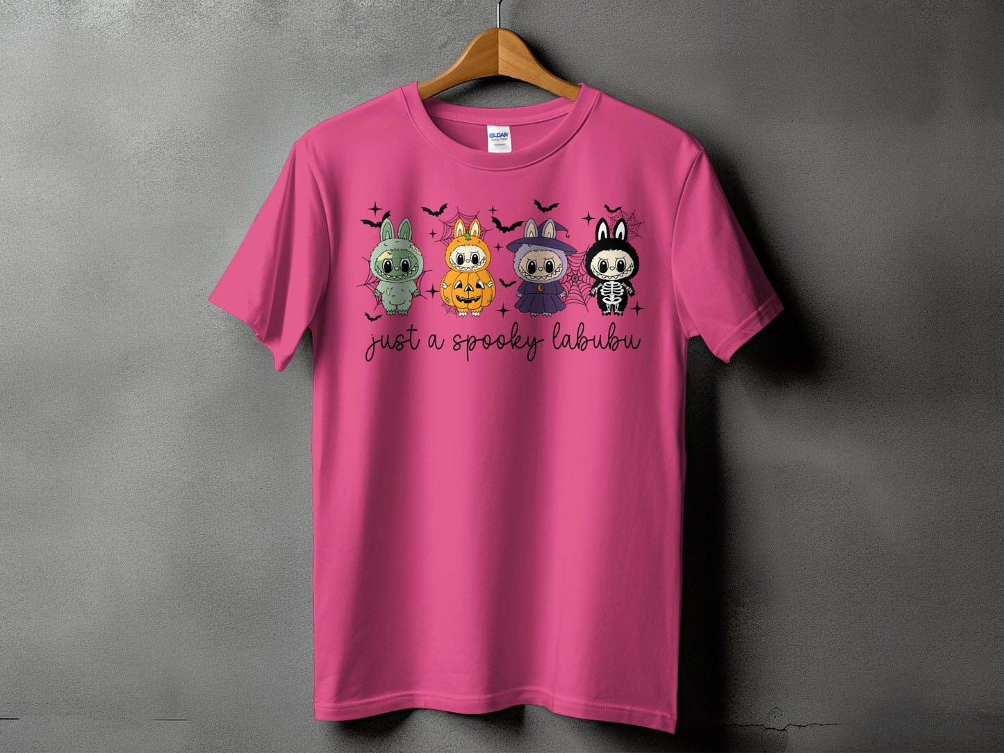 Pink t-shirt with four cartoon characters and "just a spooky labubu" text.