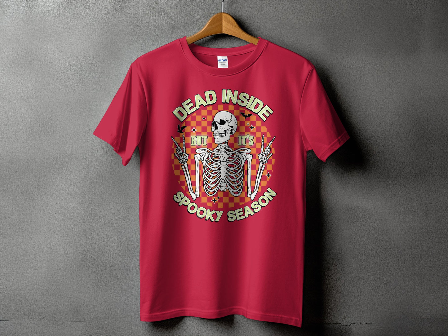 Red t-shirt with a skeleton graphic and text "Dead Inside But It's Spooky Season".