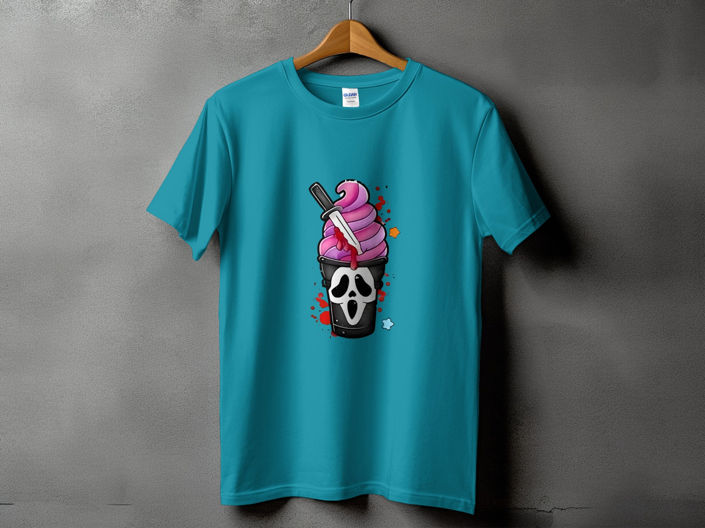 Teal t-shirt with graphic of ice cream in a cup with a ghost face and a knife.