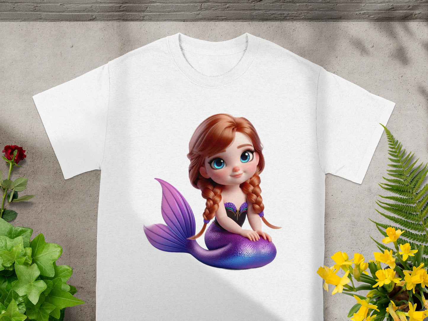 White t-shirt with cartoon mermaid with purple tail and blue eyes.