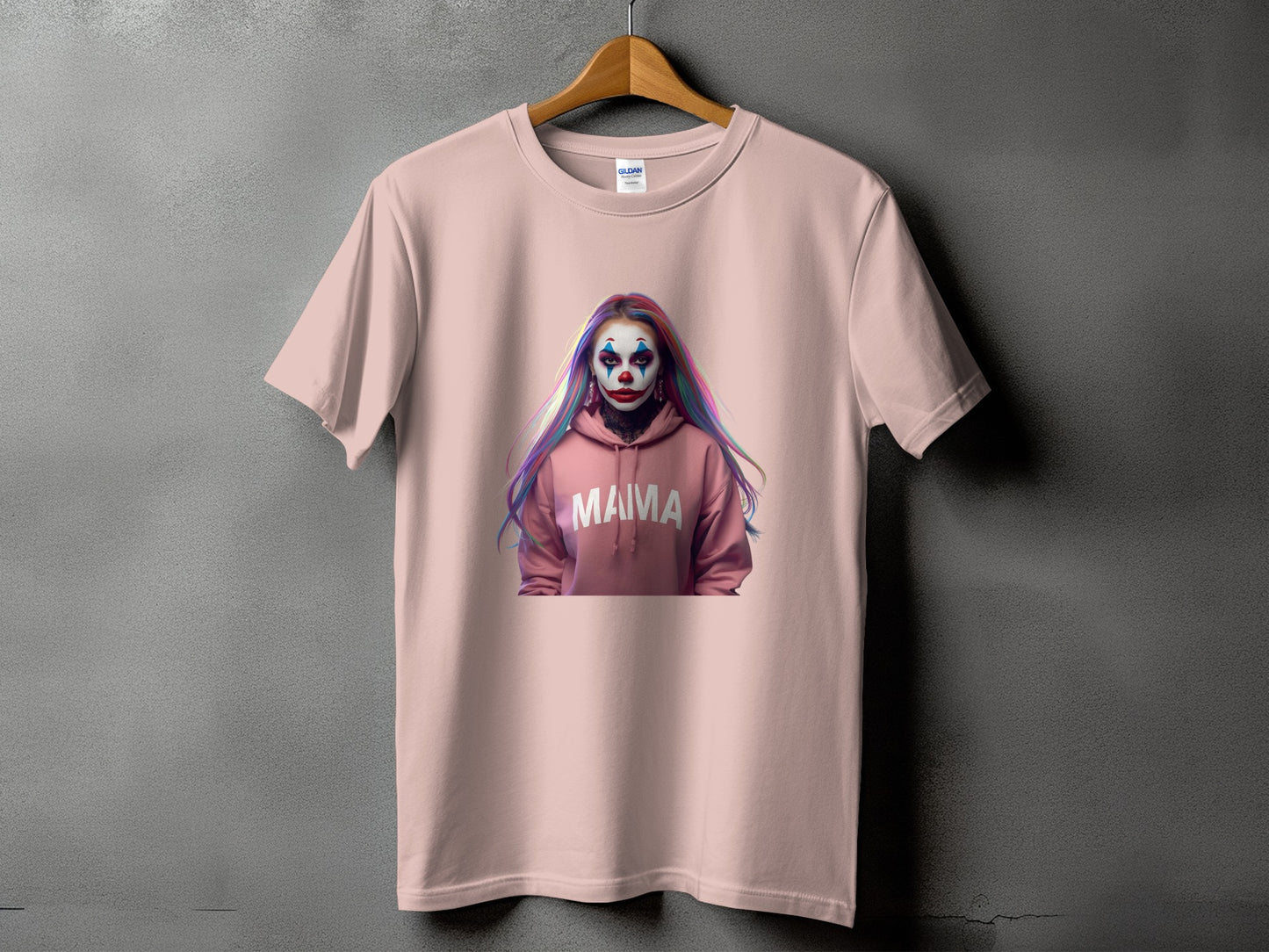 Pink t-shirt with a graphic of a person with clown makeup and the word "MAMA" on a hoodie.