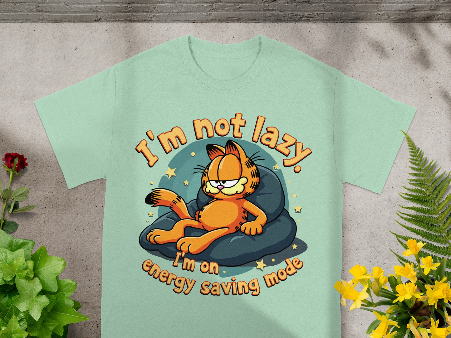 Garfield on a cushion with text "I'm not lazy. I'm on energy saving mode."