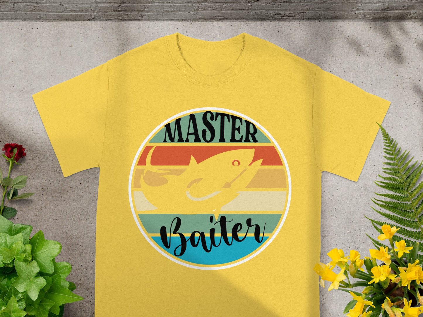 Yellow t-shirt with a circular graphic of a fish and text that says "MASTER Baiter".
