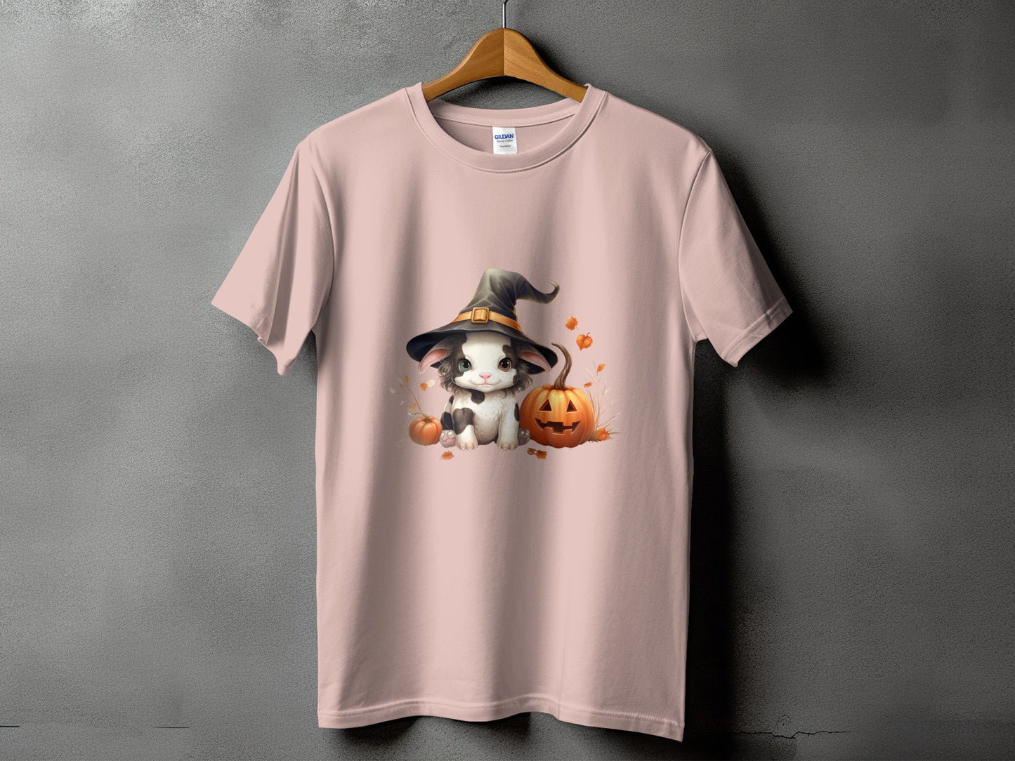 Pink t-shirt with Halloween graphic of a kitten in a witch hat and pumpkins.