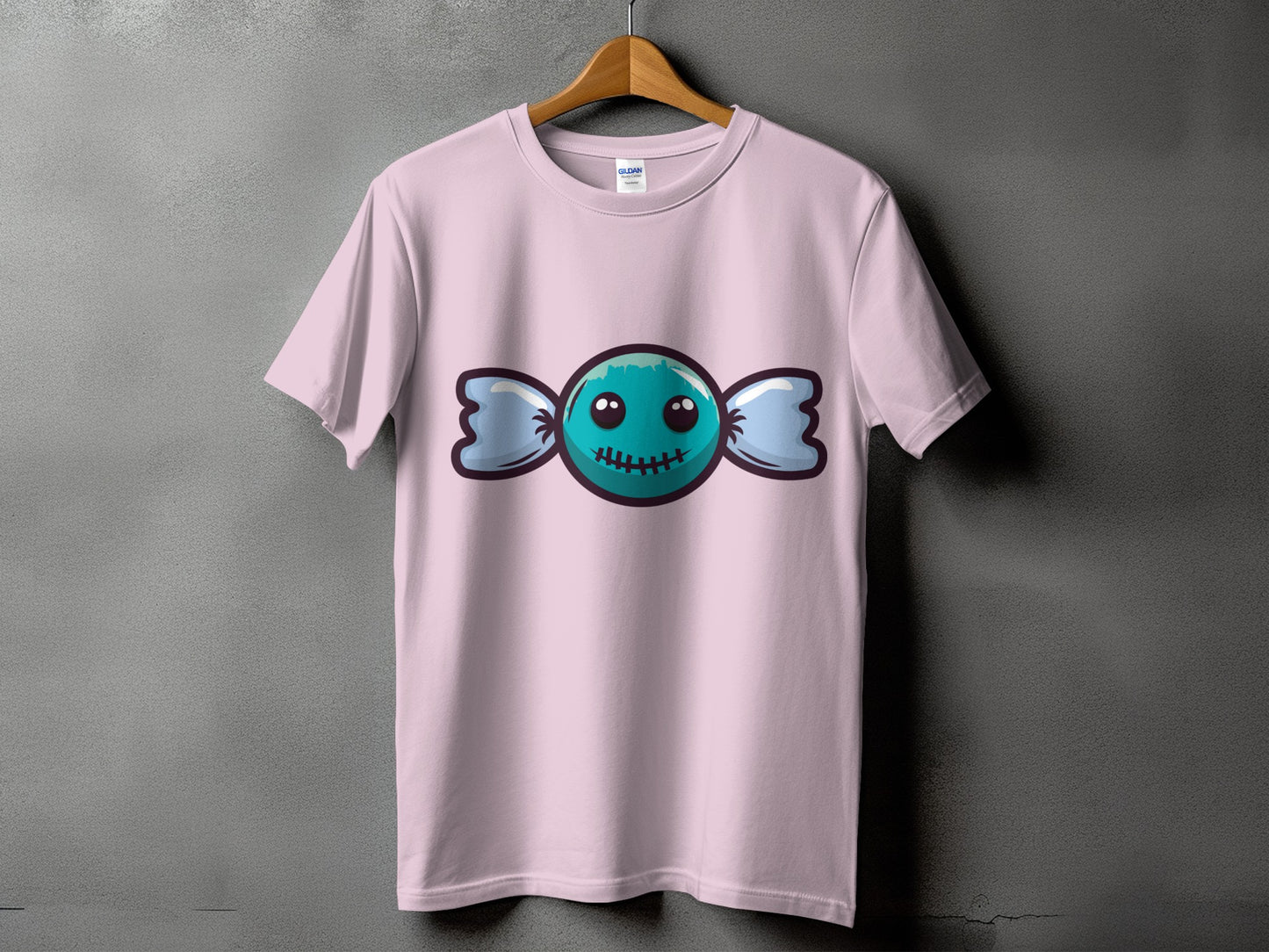 Pink t-shirt with a blue candy graphic featuring a stitched mouth and wide eyes.