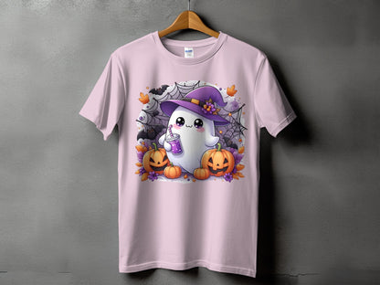 Pink t-shirt with a cute ghost wearing a witch hat and holding a drink, surrounded by pumpkins.