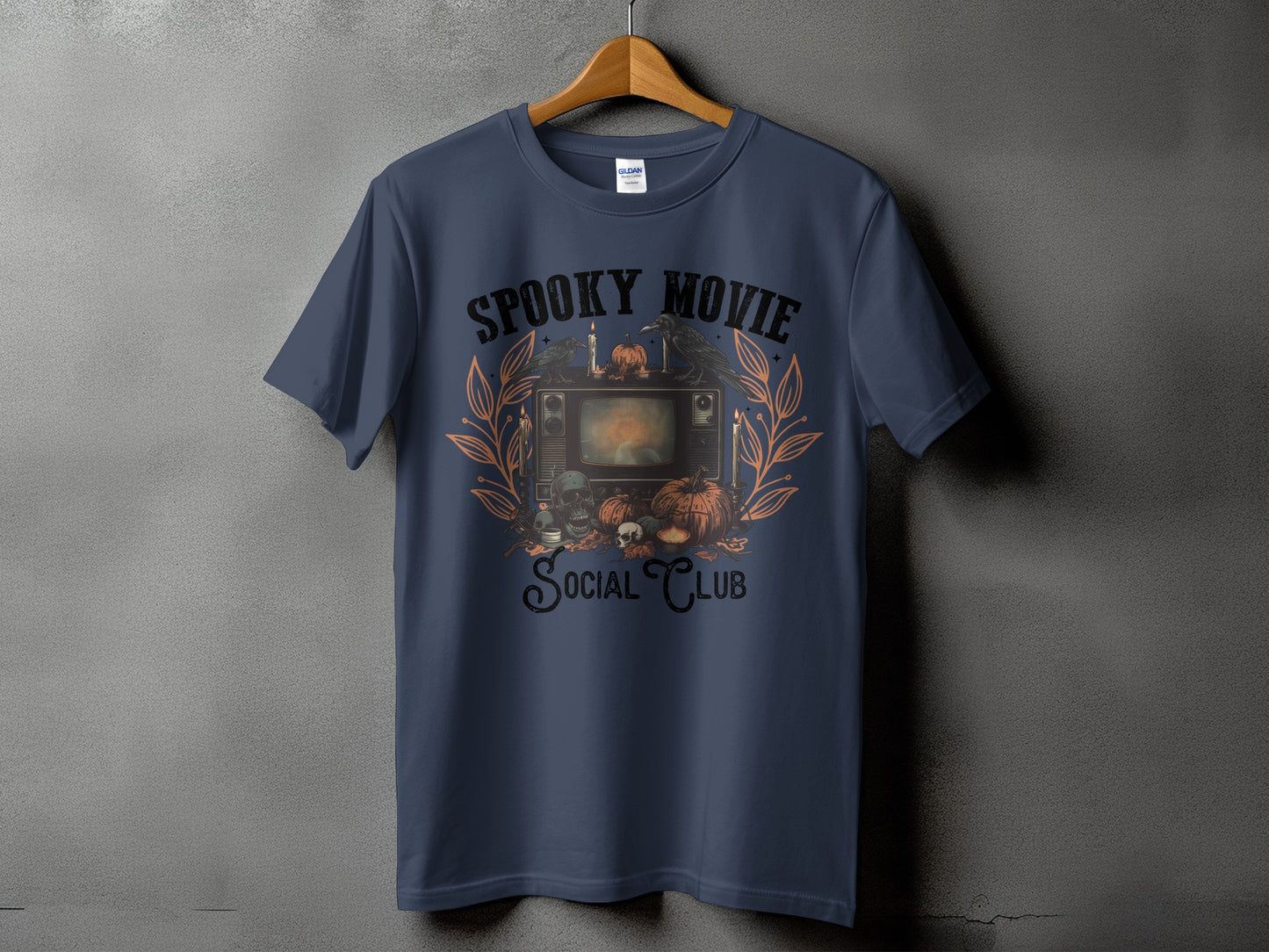 T-shirt with spooky Halloween graphic featuring vintage TV, pumpkins, skulls, and crows.