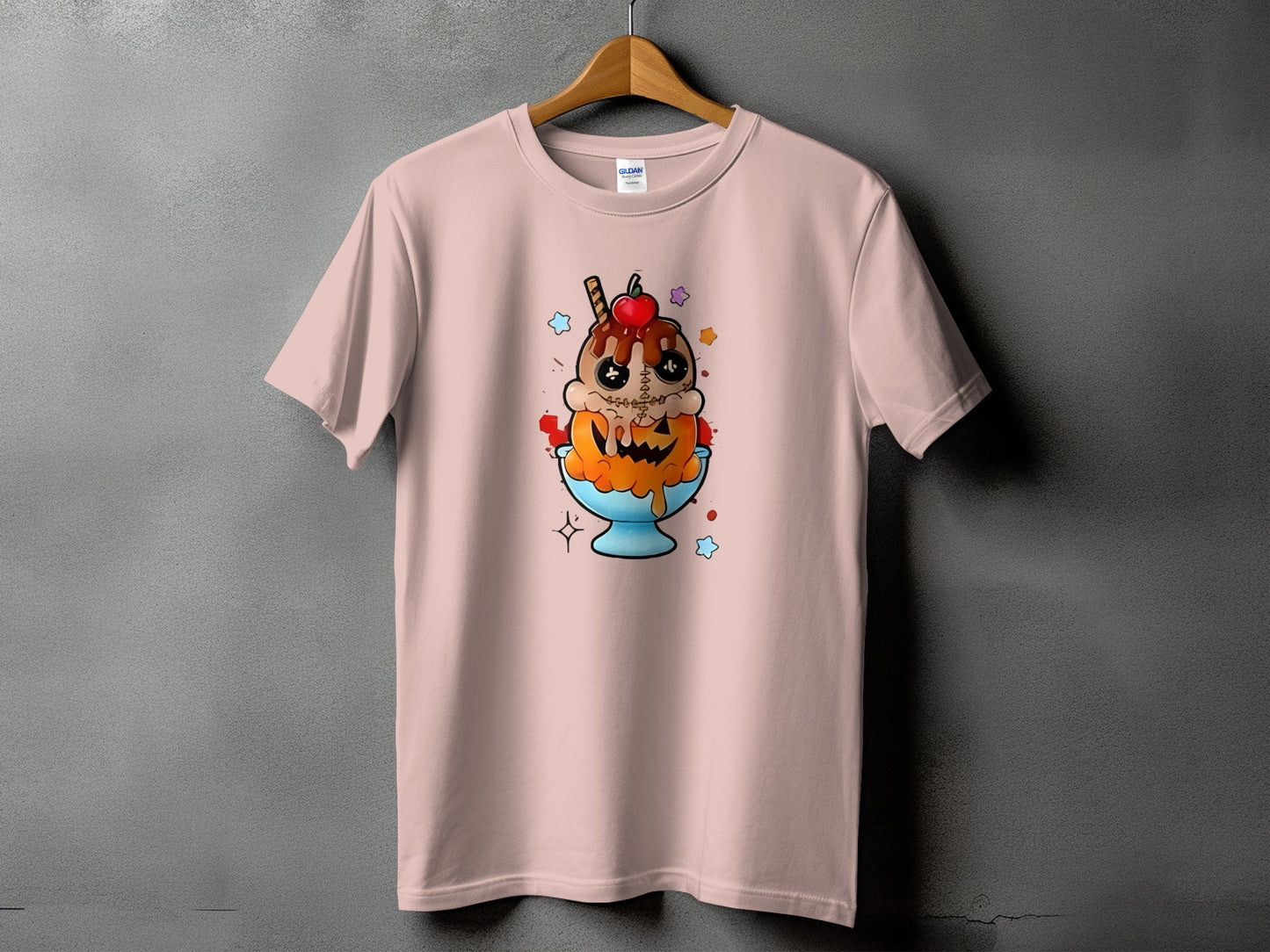 Pink t-shirt with a cartoon ice cream sundae featuring a jack-o'-lantern face.