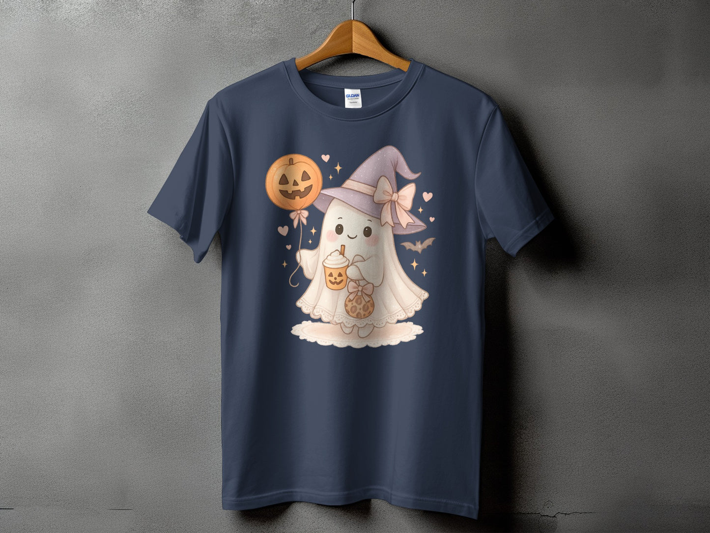 T-shirt with a cute ghost wearing a witch hat and holding a pumpkin balloon.