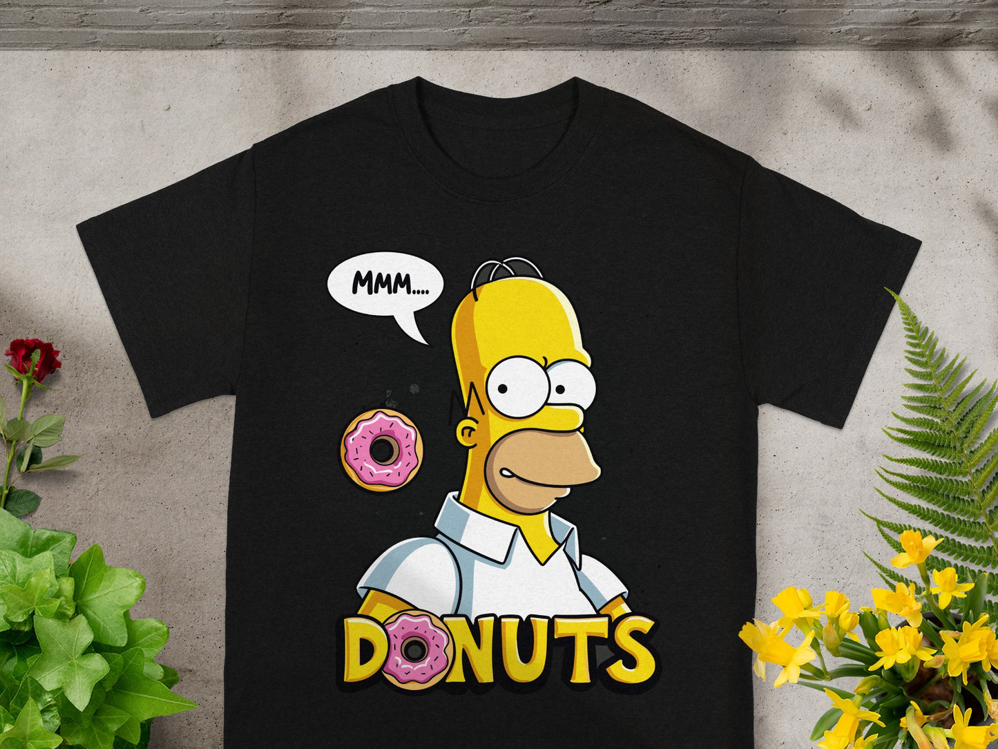 Black t-shirt featuring Homer Simpson saying "MMM.... DONUTS" with donuts.