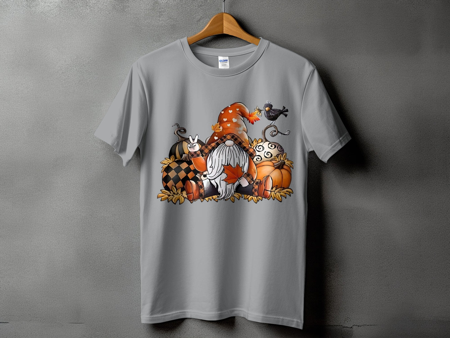 Gnome with pumpkins, plaid hat, and a bird on a t-shirt.