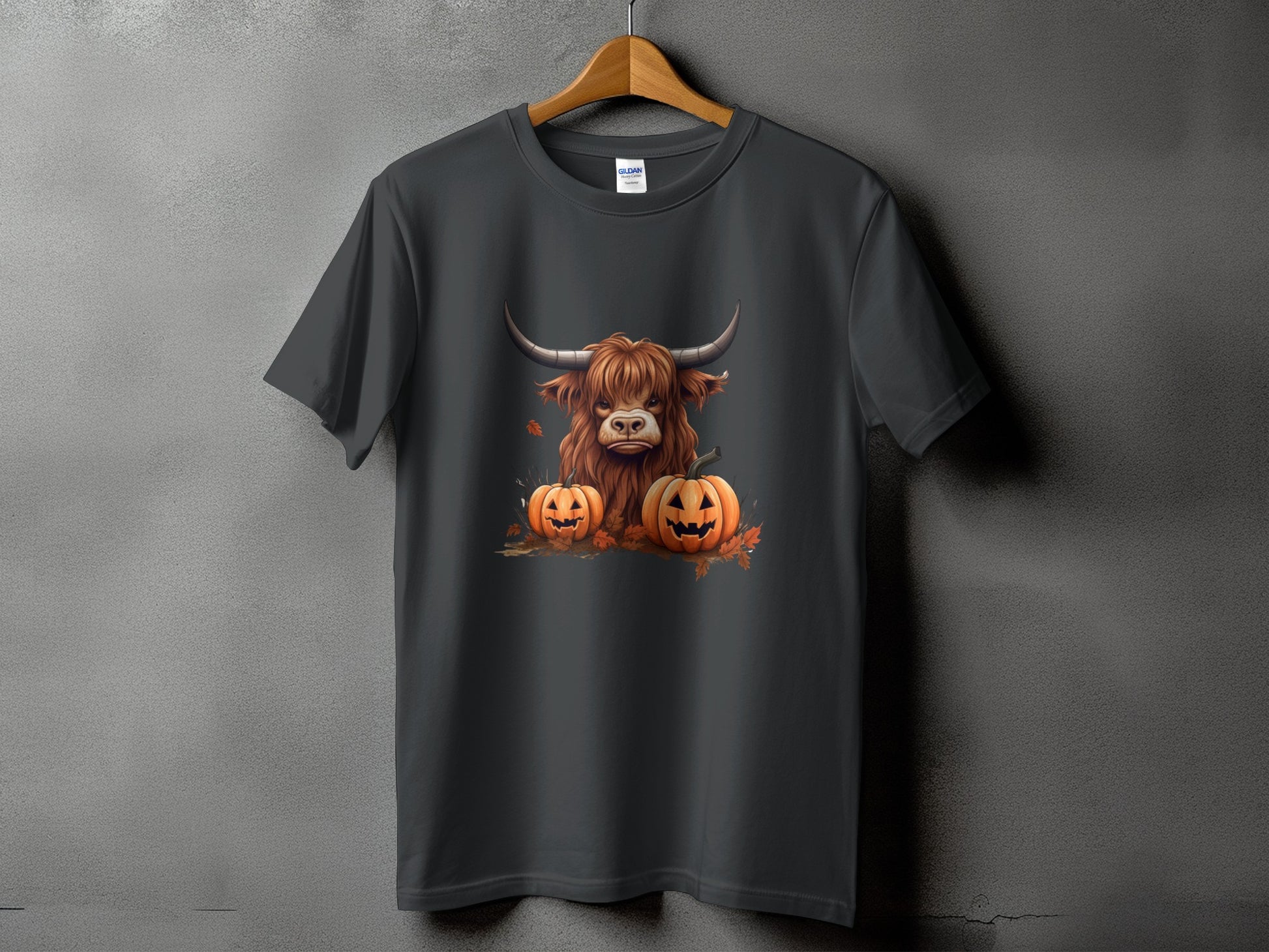 Dark grey t-shirt with a Highland cow and two jack-o'-lanterns graphic.