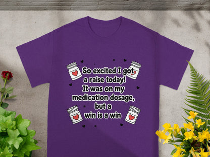 Purple t-shirt with text "So excited I got a raise today! It was on my medication dosage, but a win is a win".