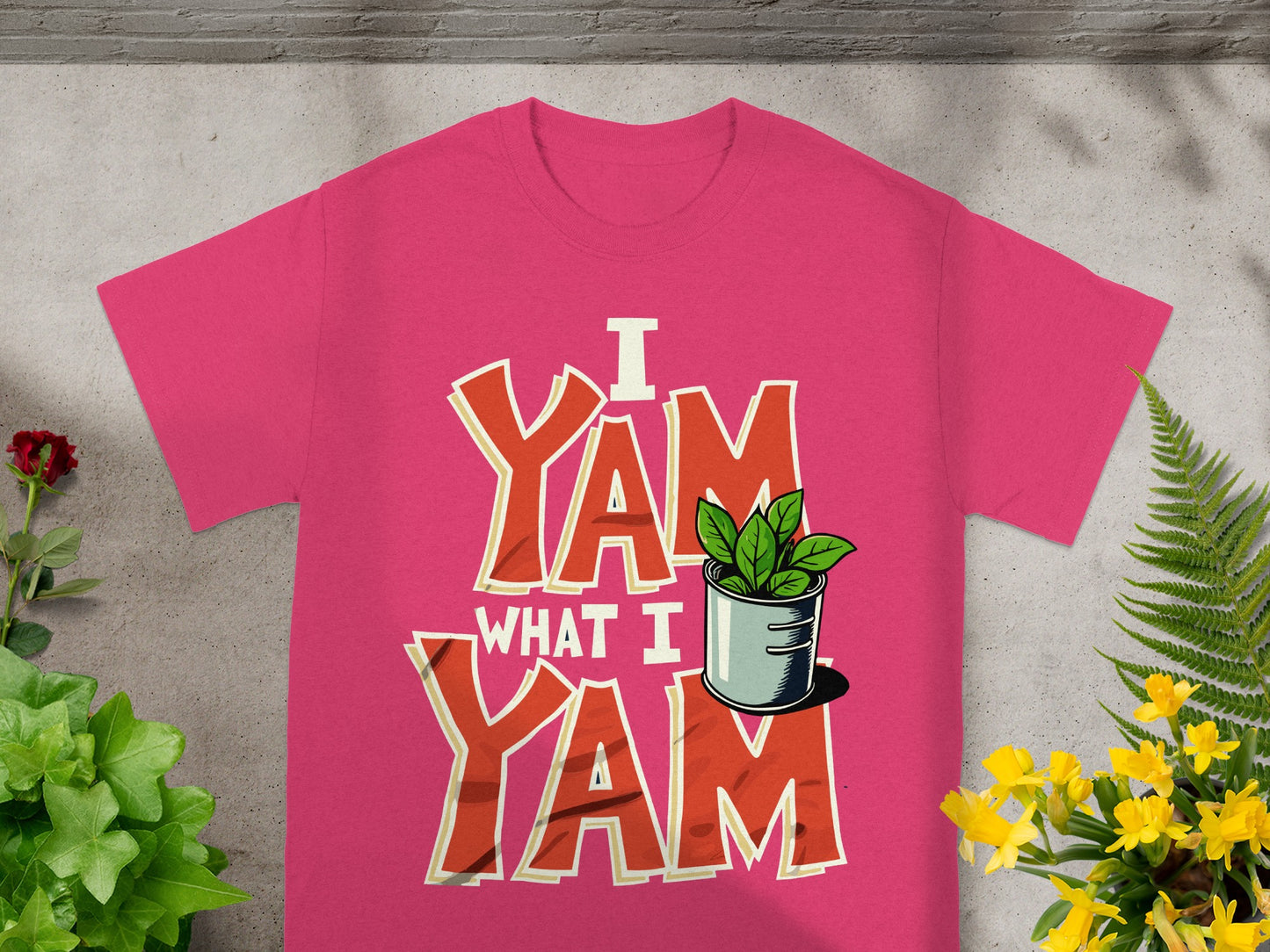 Pink t-shirt with "I Yam What I Yam" text and a potted plant graphic.