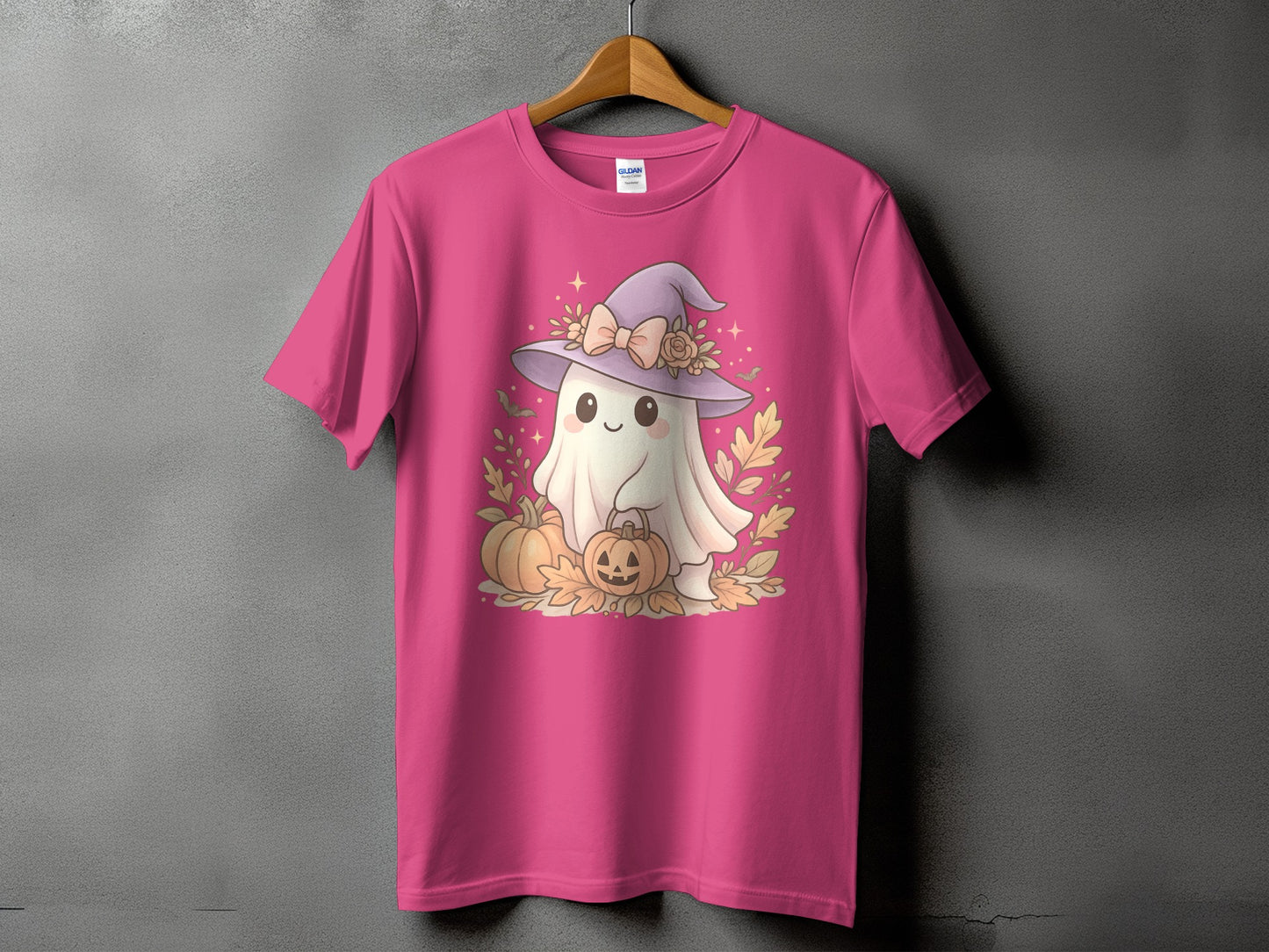 Cute ghost in witch hat with pumpkins and leaves on a pink t-shirt.