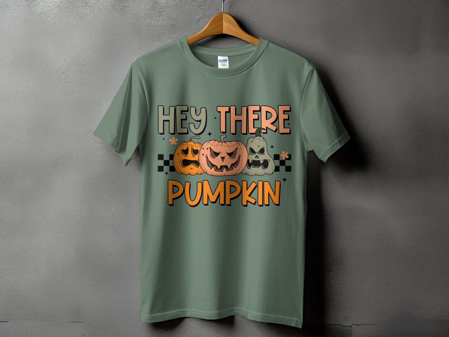 Green t-shirt with "Hey There Pumpkin" text and three Halloween pumpkins.