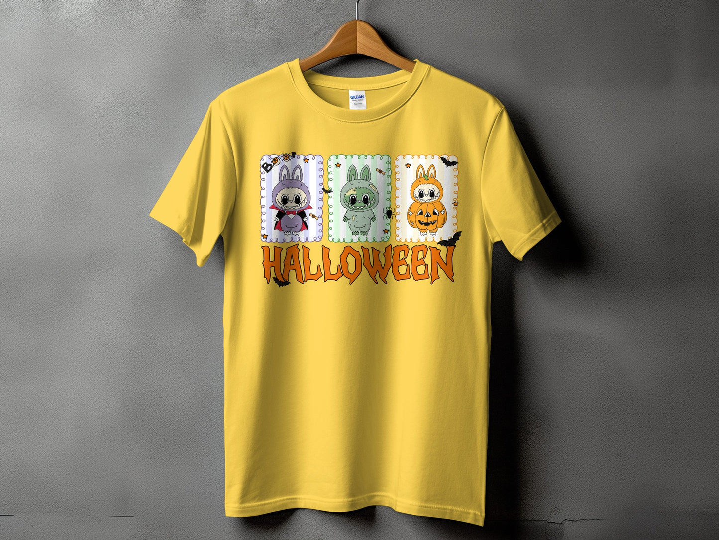 Yellow t-shirt with cartoon Halloween characters and the word HALLOWEEN in orange.